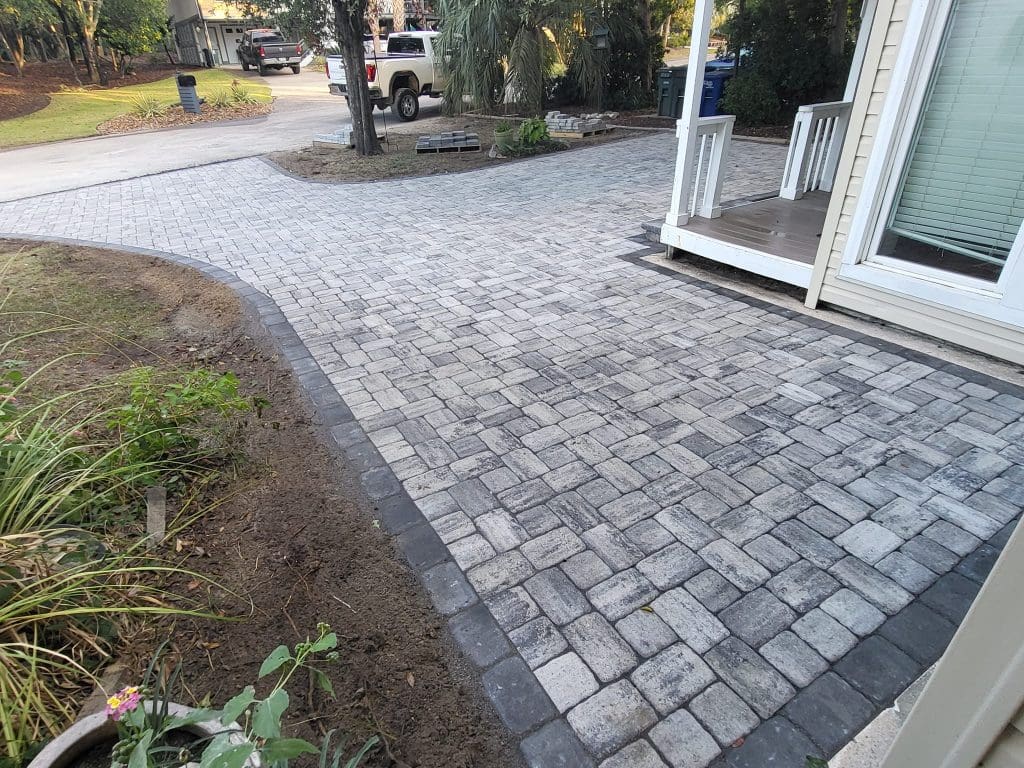 black and gray cobblestone paver stone driveway