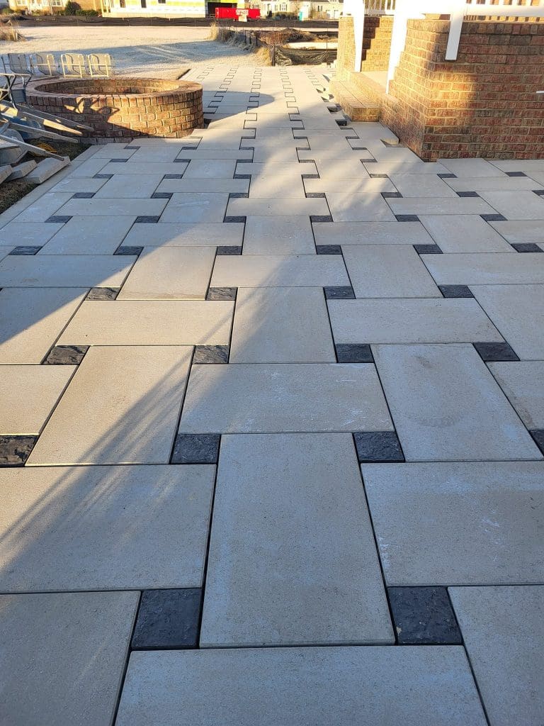 Belgard techno block pavers with a brown outdoor firepit in the background