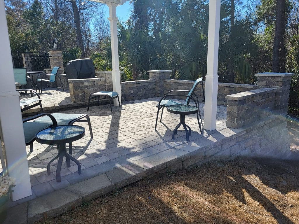 paver patio with paver wall seating in a backyard