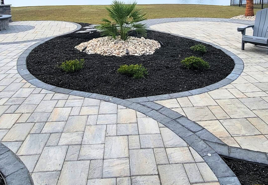 pavers and pathways around black mulch garden
