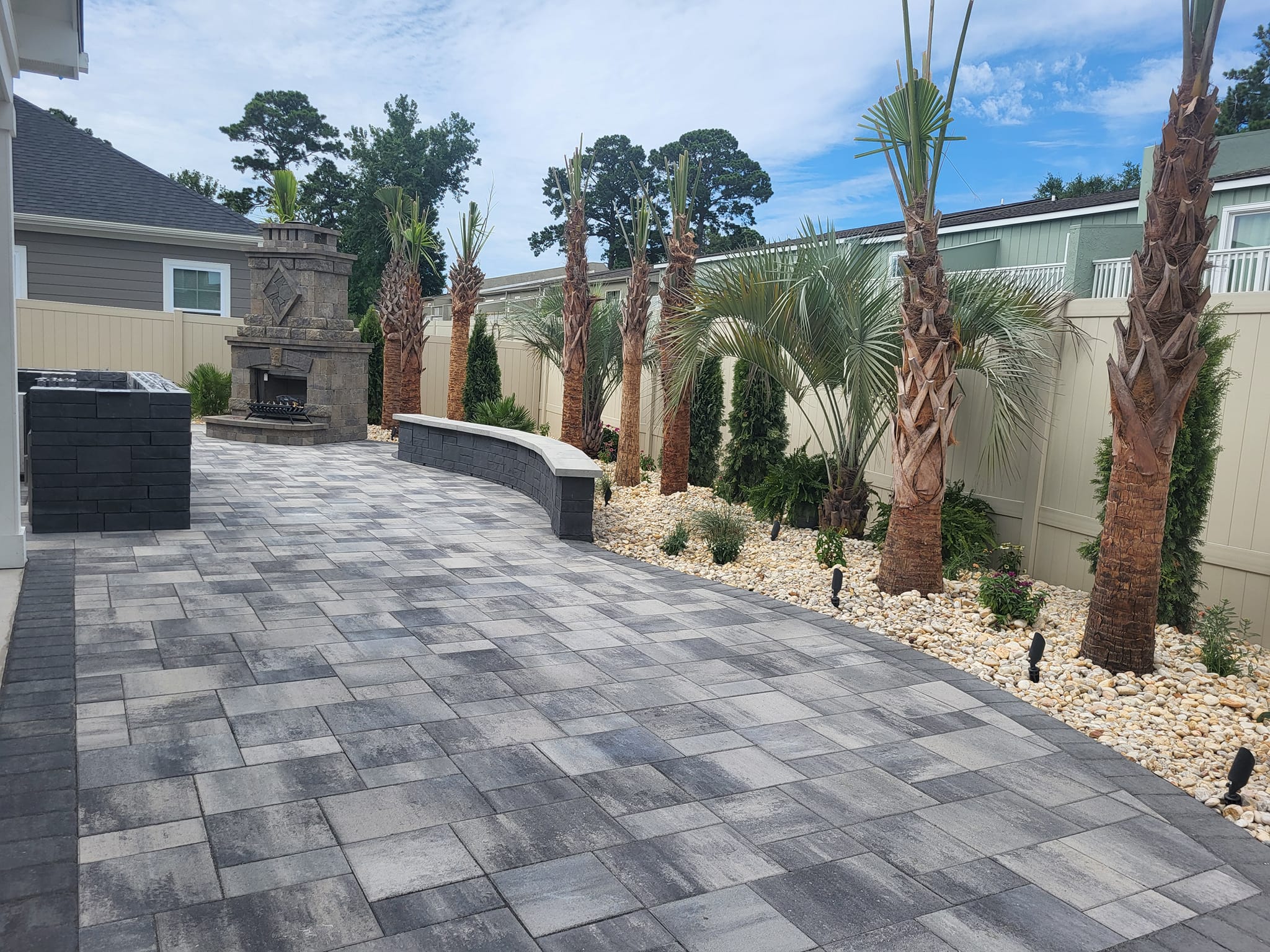brick paver patio with palm trees in the background