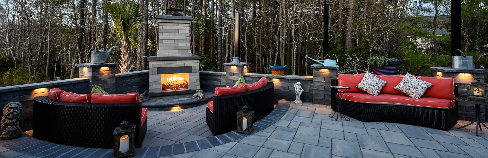 Outdoor hardscaping area with retaining wall and fireplace